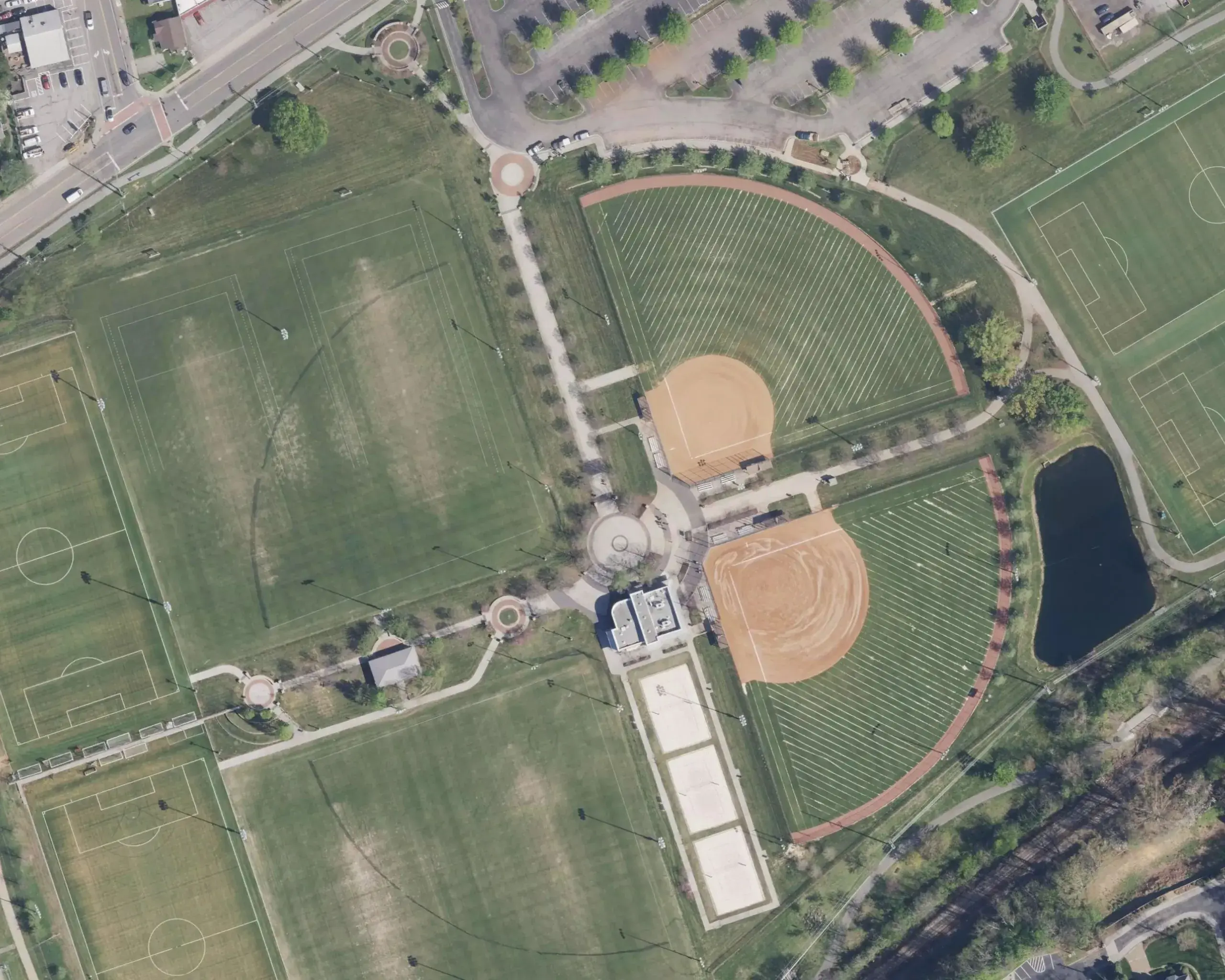 Two softball fields from above, mapped as mowing zones, with the paths between them and the charging station by the building