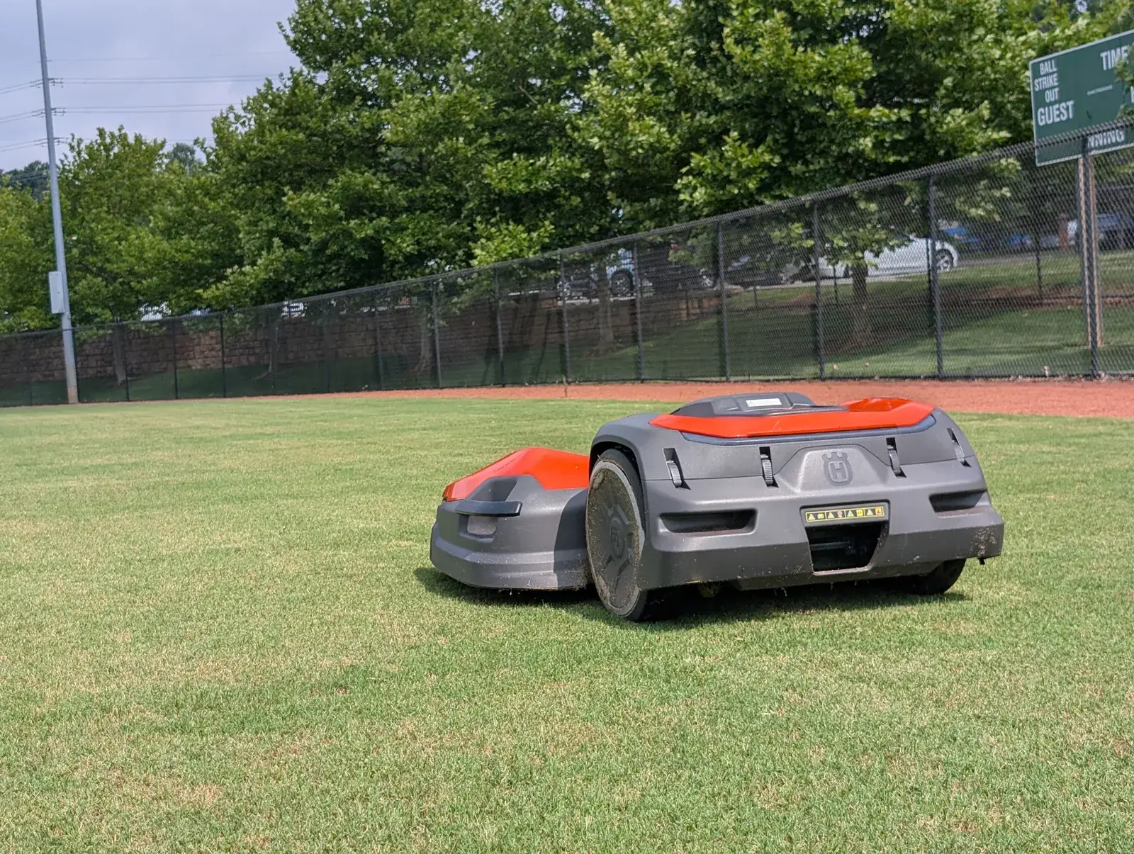 A Husqvarna CEORA robotic mower on an athletic field
