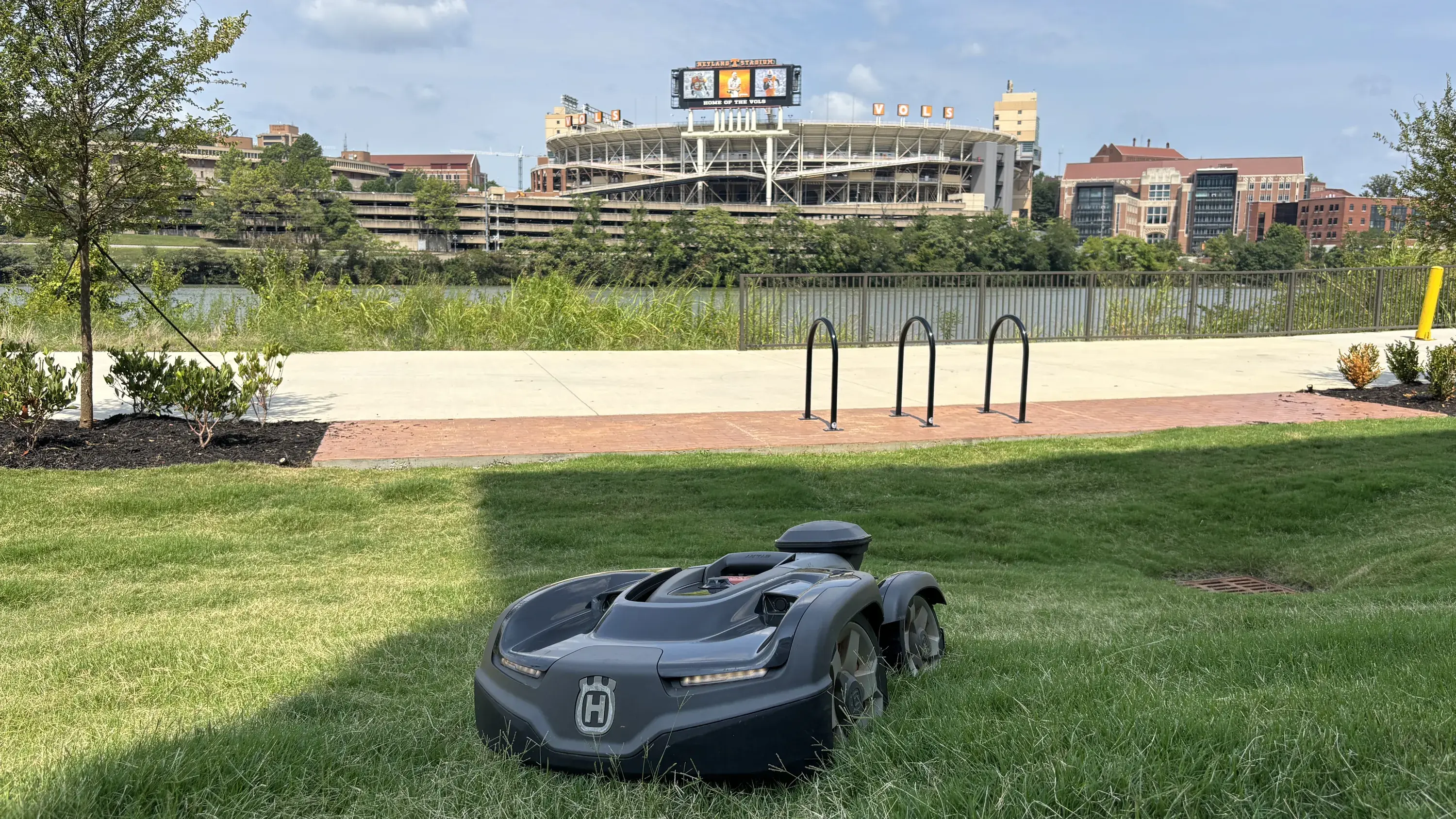 A Husqvarna robotic mower on the riverfront lawn across from Neyland Stadium in Knoxville